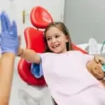 child hi fives hygienist